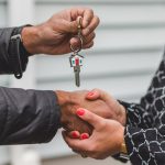 A real estate agent handing over house keys
