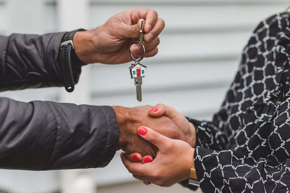 A real estate agent handing over house keys