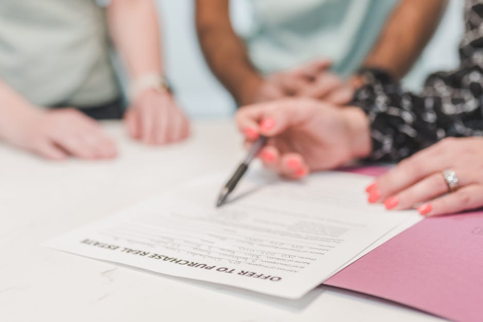 A home buyer reviewing and signing a purchase offer